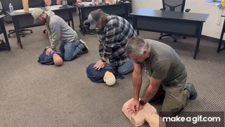 Students practicing CPR on a training manikin during a BLS class